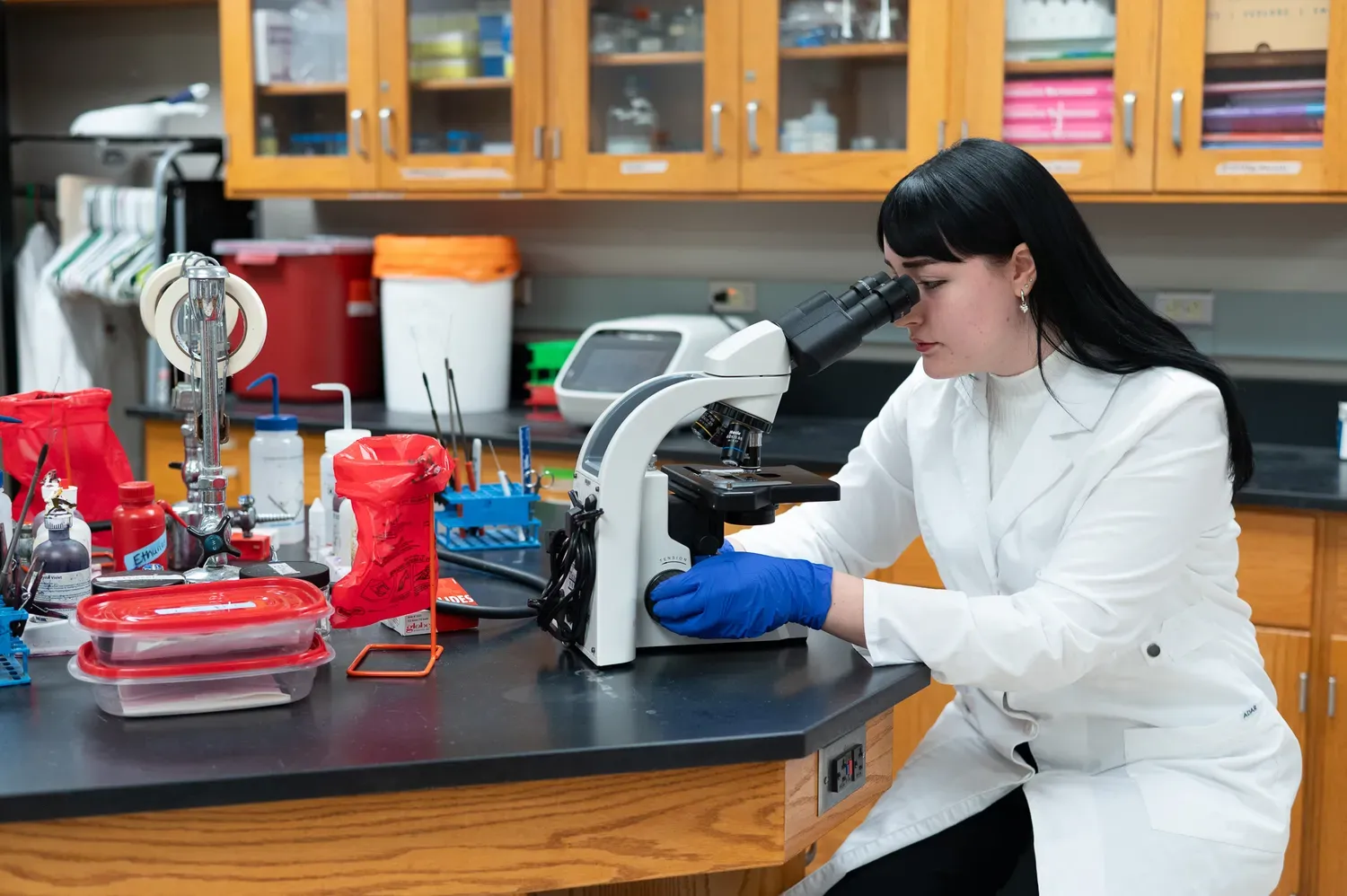 Science student looking through a microscope