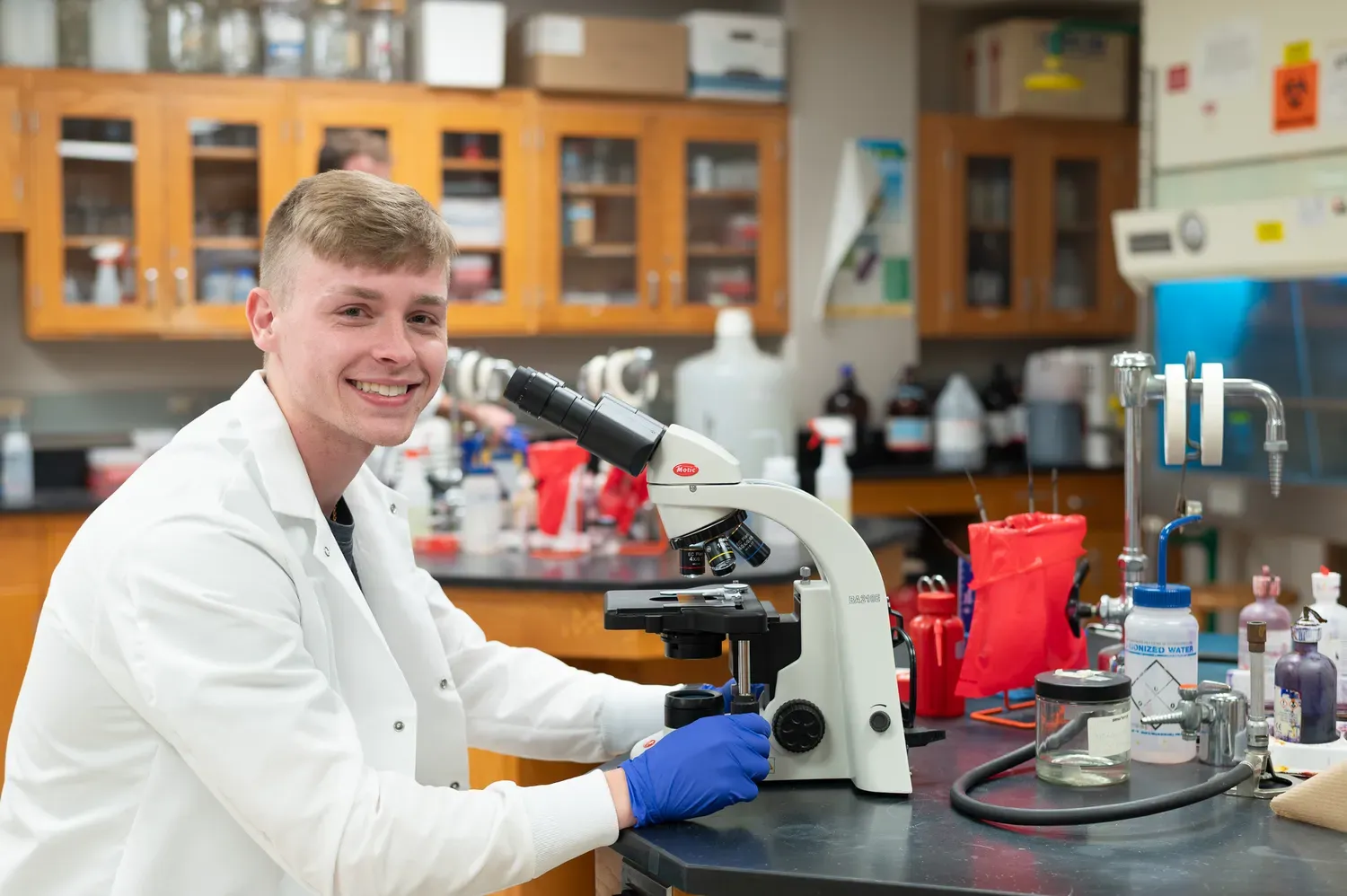 Student using microscope