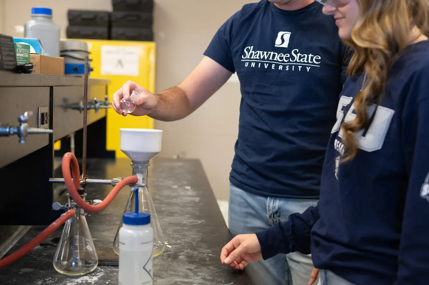 Students interacting with a bunsen burner
