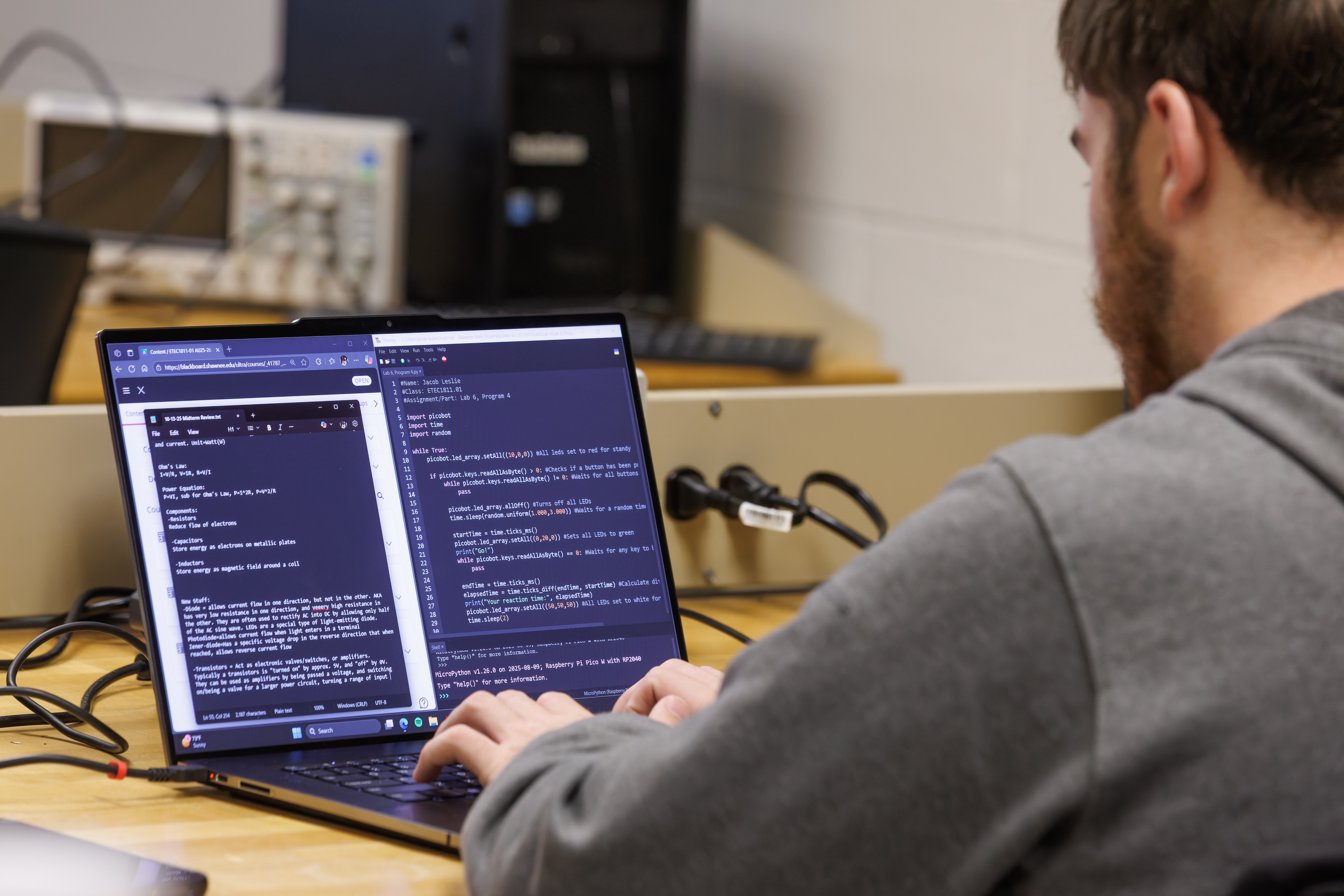 Student programing on a laptop