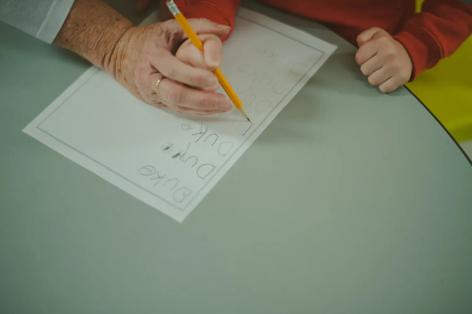 teacher helping a student write
