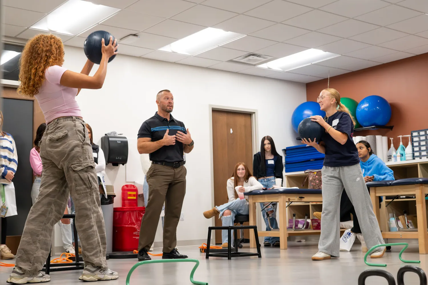 Students interacting with exercise equipment