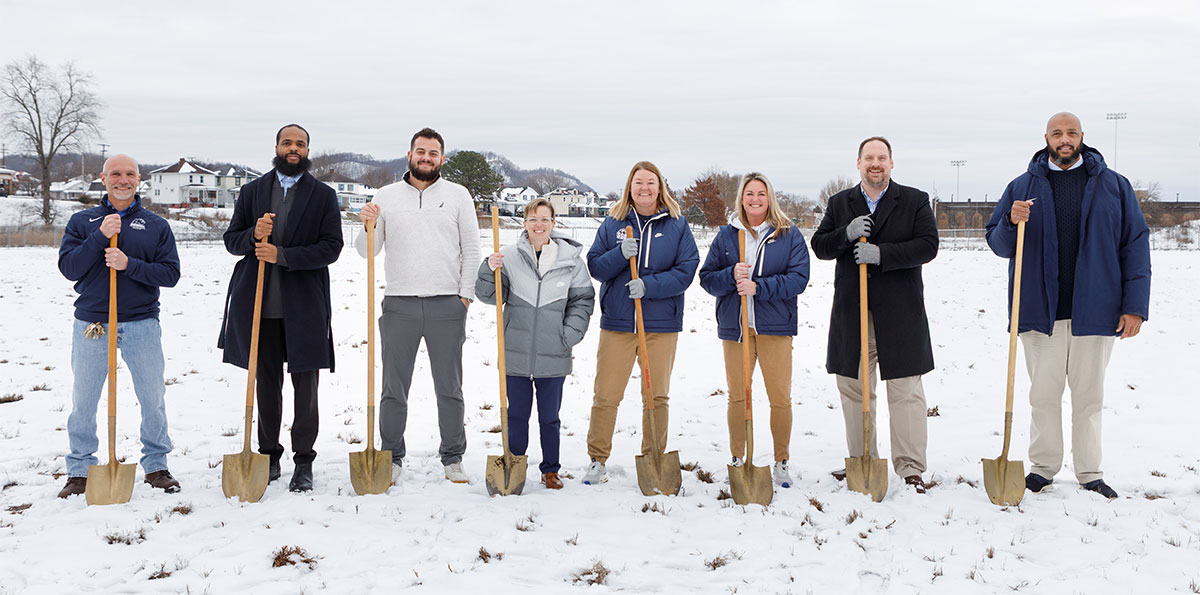 Group of people outside holding shovels